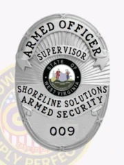 This custom metal badge for armed security features a polished silver finish in an oval shape. At the top, "ARMED OFFICER" is prominently displayed in bold lettering, with the title "SUPERVISOR" just below it in a slightly smaller font. The center showcases the state seal of West Virginia, encircled by the words "SHORELINE SOLUTIONS ARMED SECURITY." The badge also includes the number "009" at the bottom and is equipped with a safety pin attachment for secure wear.